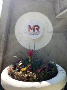a sign that says nr khodros in a flower pot at Mo rooms in Chiang Mai