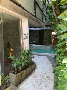 a swimming pool with plants in a building at Mo rooms in Chiang Mai