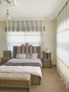 a bedroom with a large bed and a window at Jerash Heart in Jerash
