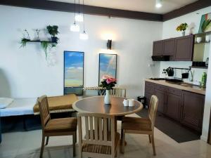 a kitchen and dining room with a table and chairs at Beachfront full sea penang in Tanjung Bungah