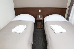 Postel nebo postele na pokoji v ubytování Sapporo Oriental Hotel