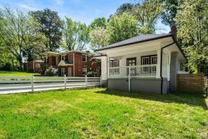 a small house with a fence in the grass at Humble Bungalow 3 Miles DT in Atlanta