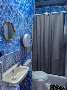 a blue bathroom with a toilet and a sink at Cristales de Antigua La Calzada in Antigua Guatemala +162 photos