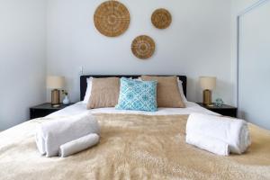ein Schlafzimmer mit einem großen Bett mit Kissen darauf in der Unterkunft Style meets comfort 2 Bed CHCH CBD in Christchurch