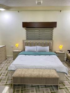 a bedroom with a large bed and two night stands at Jerash Heart in Jerash