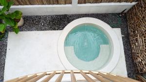 a toilet bowl with a pool of water in it at Sangkar Cottage & Eatery in Yogyakarta