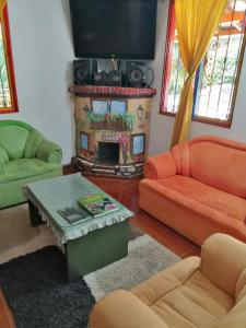 a living room with a couch and a fireplace at Casa de campo Jardín in Jardin