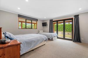 a bedroom with two beds and a window at Hāwea Delight - Lake Hāwea Holiday Home in Lake Hāwea