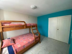 a bedroom with two bunk beds and a closet at Hemingway Salinas Apartment in Salinas