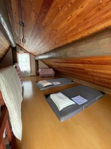 a room with two beds in a boat at しぇろくまサウナ＆カフェ in Shinano