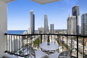 a balcony with a table and chairs and a view of the city at Ocean View Studio with Rooftop Jacuzzi in Gold Coast