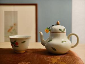 a tea pot and a cup on a table at Rest collection Gion-Shijo Kyoto in Kyoto