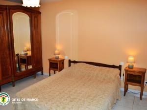 a bedroom with a bed and two night stands and two mirrors at Longère authentique avec jardin privé, près des Châteaux de la Loire, idéale pour familles et nature - FR-1-381-501 in Saint-Laurent-de-Lin