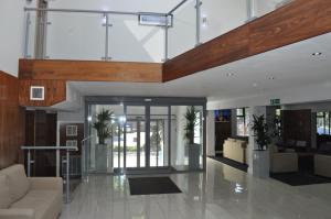 a lobby with a staircase and a living room at The Collection Hotel Birmingham in Birmingham