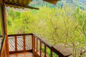 een veranda van een hut met uitzicht op een bos bij Homestay Chu Vang in Phong Thổ