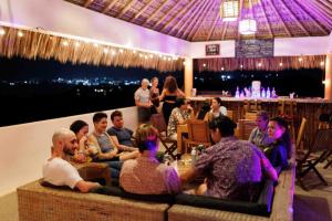 een groep mensen die in een bar zitten bij Villa Bonobo in Puerto Escondido