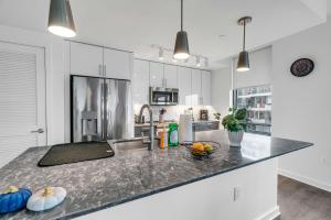 a kitchen with white cabinets and a counter top at Waterfront Two Bedroom apartment in a brand new building apts in Washington