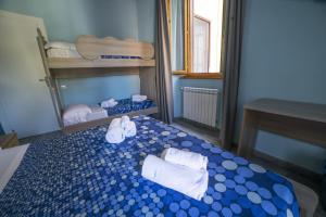 a bedroom with a bed with towels on it at B&B Porta Livorno in Civitavecchia