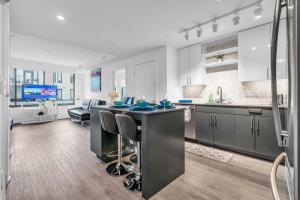 a kitchen with a island in the middle of a room at Two Bedroom Fully Furnished Apartment near Waterfront apts in Washington, D.C.