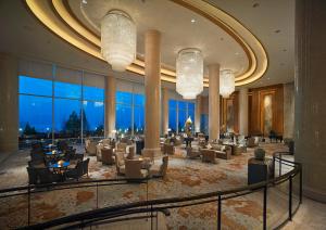 a lobby with couches and chairs in a building at Shangri-La Qinhuangdao in Qinhuangdao