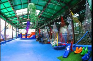 a play room with a playground with slides and swings at Flat SP no Hotel Wyndham Ibirapuera - Moema in São Paulo