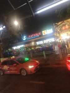 a car parked in front of a restaurant at night at Good Nice GN in Bangkok