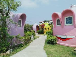 una casa con caras pintadas en un lateral. en Kenting Ha-Bi Star Fort, en Hengchun