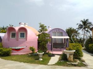 a house with a face painted on the side of it at Kenting Ha-Bi Star Fort in Hengchun