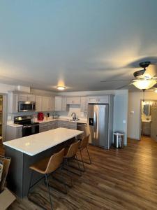 a kitchen with a table and chairs and a refrigerator at Top floor lakefront condo with Mountain Views! in Wasilla
