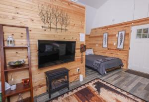 a bedroom with a fireplace and a flat screen tv at Peaceful Barn Getaway Fire Pit & Daybed FREE PK in Atlanta