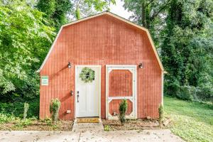 a small red barn with a white door at Peaceful Barn Getaway Fire Pit & Daybed FREE PK in Atlanta