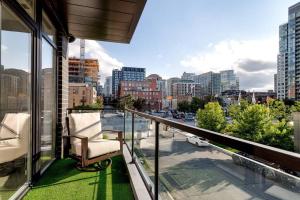 a balcony with a chair and a view of a city at 2 Newly Built Luxury Condos with Private Roofdeck in Chicago