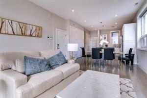 a living room with a couch and a dining room at 2 Newly Built Luxury Condos with Private Roofdeck in Chicago