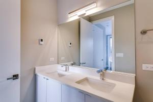 a bathroom with two sinks and a large mirror at 2 Newly Built Luxury Condos with Private Roofdeck in Chicago +44 photos