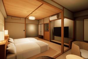 a bedroom with a white bed and a television at Ooedo Onsen Monogatari Premium Hotel Sokan in Matsushima