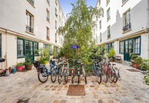 un groupe de vélos garés à côté des bâtiments dans l'établissement Renovated ! City of Lights, light your visit, à Paris