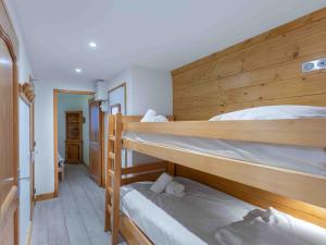 a room with two bunk beds in a house at Charmant appartement Méribel Centre avec balcon et parking - FR-1-565-105 in Les Allues