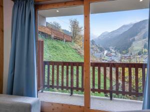 a room with a window with a view of a mountain at Charmant appartement Méribel Centre avec balcon et parking - FR-1-565-105 in Les Allues