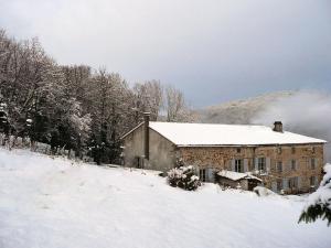 a building covered in snow in a snowy field at Gîte Sauvain, 5 pièces, 12 personnes - FR-1-496-315 in Sauvain