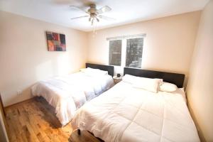a bedroom with two beds and a ceiling fan at Tucked Away Off Brady - 4 Beds in Milwaukee