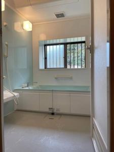 a bathroom with a sink and a window at Wood retreatみやざき in Miyazaki +12 photos
