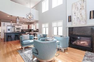 a living room with chairs and a fireplace at Eclectic Stylish and Cozy Milwaukee Home in Milwaukee