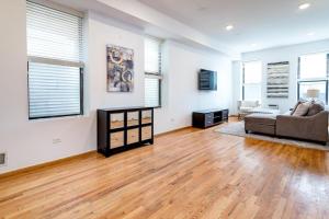 a living room with a couch and a tv at Central Chicago Suite2 Access to Patio in Chicago