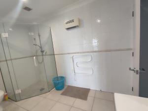 a bathroom with a shower and a glass shower stall at Home with sea views in New Plymouth