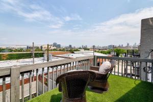 a balcony with a chair and a view of the city at Stunning 2 Floor Penthouse Downtown in Chicago