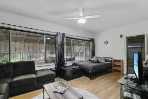 a living room with a couch and a tv at Bonney Shores in Barmera
