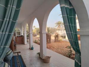 a view from the balcony of a house with arches at Djerba rêve vacances Zohra in Midoun