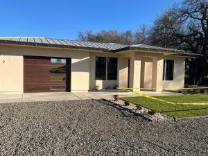 a house with a garage and a driveway at Two bedroom with river access in Redding