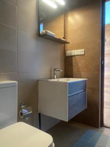 a bathroom with a sink and a toilet at Lion Gate Hotel Sigiriya in Sigiriya