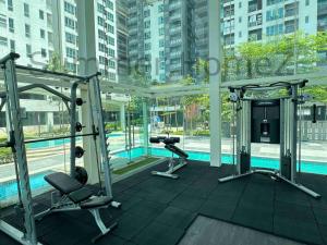 a gym with two treadmills and a swimming pool at 3BR 5-6Pax Zetapark Setapak Central, Lake View in Kuala Lumpur